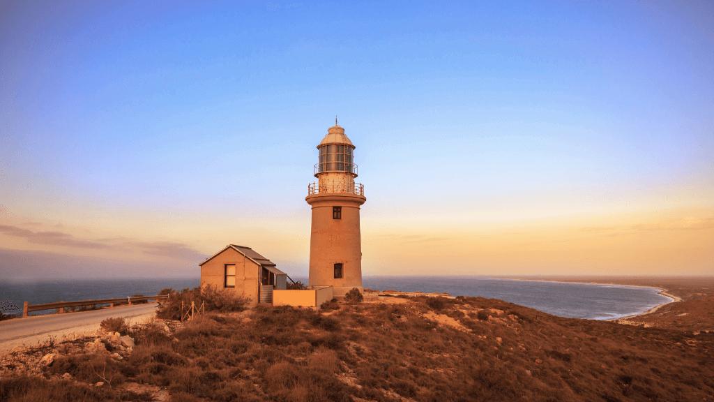 Historic lighthouse overlooking Ningaloo Coast at sunset, a scenic stop on the 3-Day Kayak & Snorkel Safari adventure.