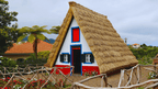 Iconic triangular thatched house in Santana, a cultural stop on the 6-days hiking Madeira’s trails itinerary.