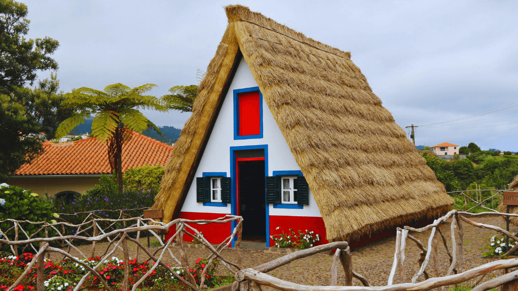 Iconic triangular thatched house in Santana, a cultural stop on the 6-days hiking Madeira’s trails itinerary.