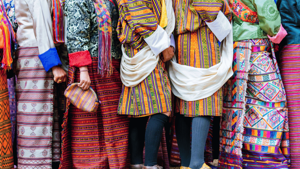 Colorful traditional Bhutanese attire worn during a cultural event on the Trans Bhutan Trail with hotel or camping options.