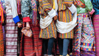 Colorful traditional Bhutanese attire worn during a cultural event on the Trans Bhutan Trail with hotel or camping options.