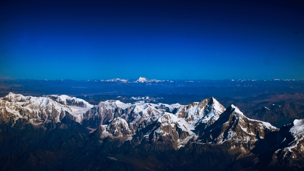 Snow-capped Himalayan peaks viewed from the Trans Bhutan Trail, offering breathtaking scenery for trekkers.