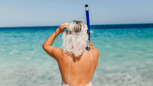 Woman preparing to snorkel in turquoise waters on the Ningaloo Safari 3-Day Kayak & Snorkel Tour. Great for beach and ocean lovers.