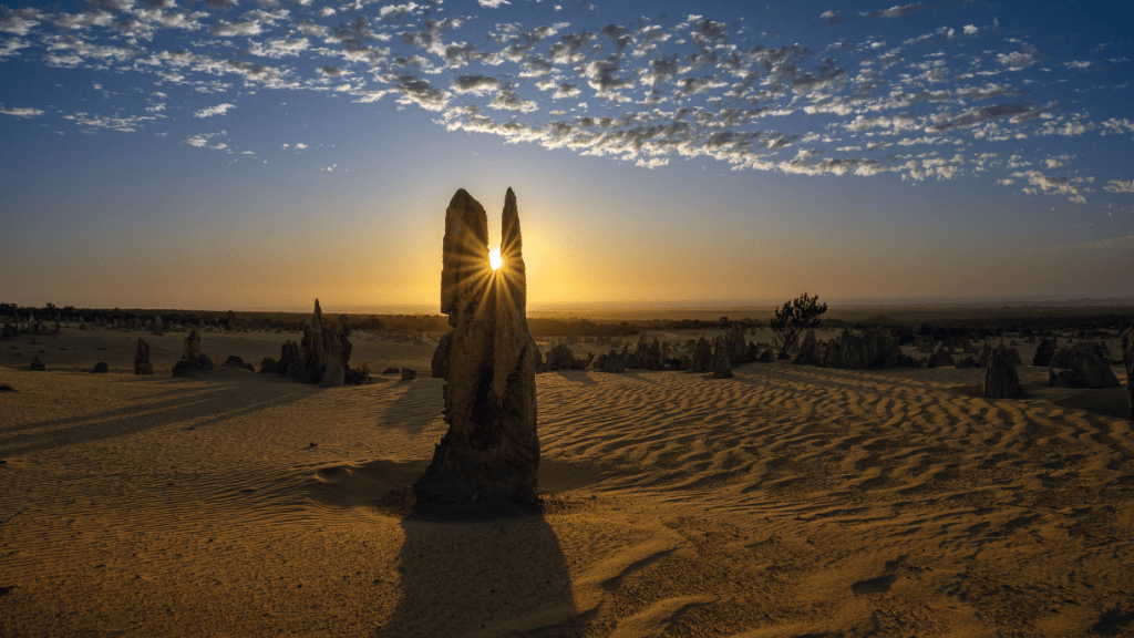 Sunset over Pinnacles Desert with golden rock spires on West Coast Road Trip. Iconic natural wonder in Western Australia.