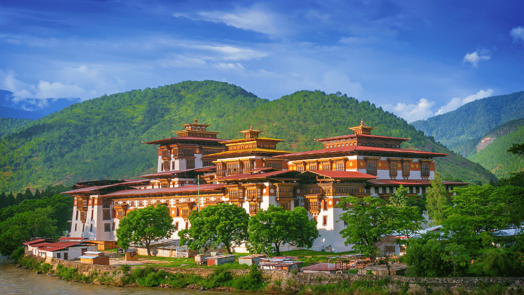Punakha Dzong surrounded by lush greenery, a major cultural stop on the Trans Bhutan Trail adventure.