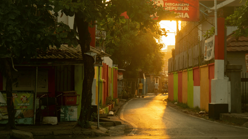 Colorful alleyway in a Sulawesi village at golden hour, capturing local life on the Soul of Sulawesi - Tana Toraja Culture Tour.