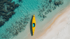 Yellow kayak on clear shoreline, aerial view from the Ningaloo Safari 3-Day Kayak & Snorkel Tour. Ideal for solo paddlers.