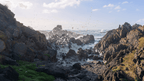 Rocks and waves at a coastal area with a clear sky