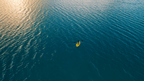 Solo kayaker paddling at sunset on calm ocean waters during the Ningaloo Safari 3-Day Tour. Ideal for tranquil outdoor escapes.