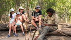 Family watches Aboriginal guide craft tools on Kakadu Katherine Gorge Tour | 4-Day Comfort Travel. Educational cultural demonstration.
