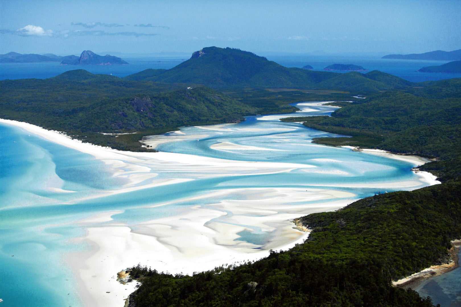 Aerial view of Whitehaven Beach’s swirling sands, a key destination on the Whitsundays Reef Tour from Brisbane to Cairns. Iconic tropical stop.