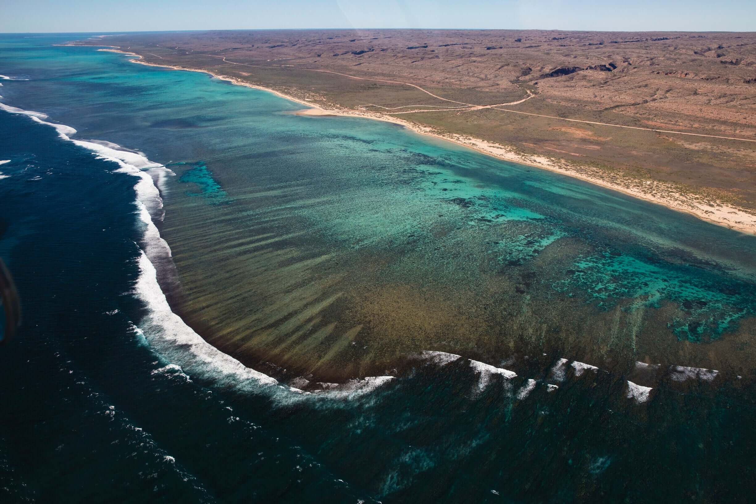 Aerial view of Ningaloo Reef coastline during West Coast Road Trip from Perth to Exmouth. Scenic marine landscape in Western Australia.