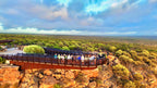 Tour group on Kalbarri Skywalk overlooking Murchison River Gorge during West Coast Road Trip. Scenic viewpoint in Western Australia.