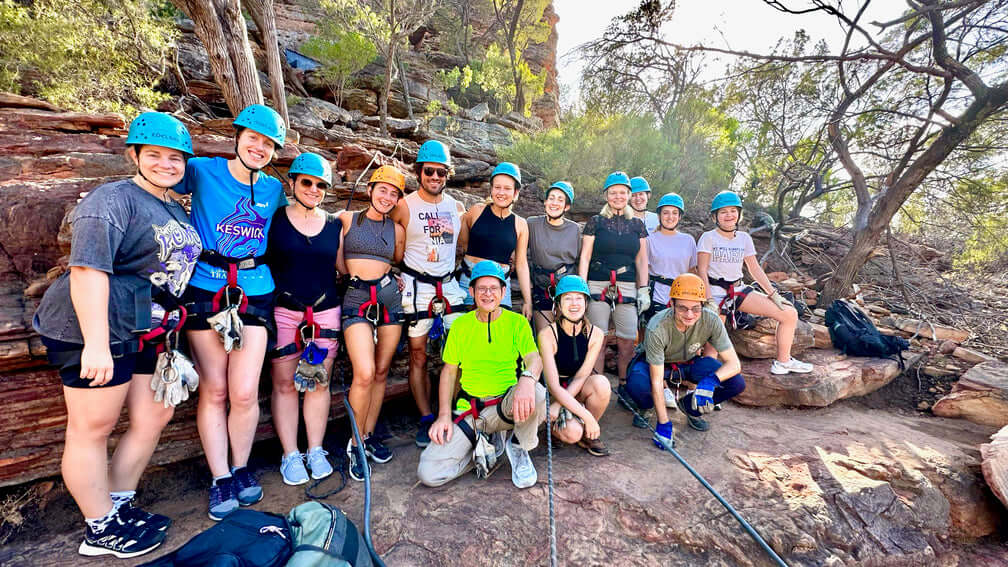 Group of travelers geared up for rock climbing in Kalbarri National Park on West Coast Road Trip. Outdoor recreation in Western Australia.