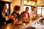 Travelers enjoying food and drinks at local eatery on East Coast Australia tour. Culinary experience on 8-day Sydney to Brisbane trip.