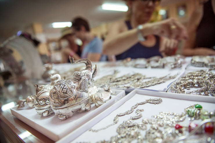 Silver elephant figurines and jewelry in a Cambodian market, featured in the Angkor to Islands 16-Day Tour - Khmer Culture to Thai Coasts.