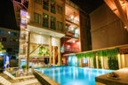 Colorful hotel with pool lit at night, offering comfort on the Angkor to Islands 16-Day Tour - Khmer Culture to Thai Coasts.