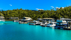 Luxury boats docked at Hamilton Island marina on East Coast Adventure 14/16-Day Small-Group Tour. Gateway to Whitsundays sailing.