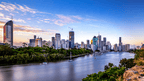 Brisbane city skyline and river at dusk on East Coast Adventure 14/16-Day Small-Group Tour. Urban stop along Australia’s east coast.