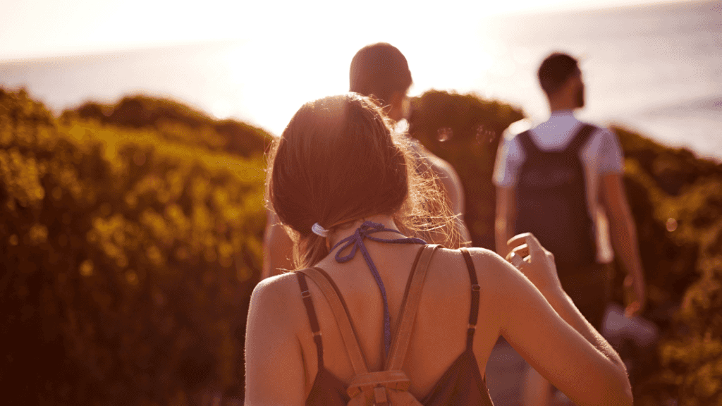Small group hiking along coastal trail at sunset on East Coast Adventure 14/16-Day Small-Group Tour. Ideal for active explorers in Australia.