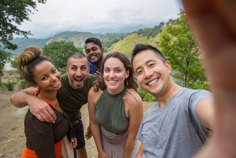 Group selfie with smiling travelers in Sri Lanka's hill country. Explore Sri Lanka - Land & Sea Tour Options includes social and scenic experiences.