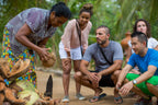Local woman demonstrating coconut preparation to travelers. Explore Sri Lanka - Land & Sea Tour Options includes hands-on cultural activities.
