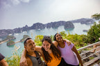 Group enjoying panoramic view of Hạ Long Bay from a scenic lookout. Highlight of Vietnam Hiking and Cycling Tour exploring limestone bays.