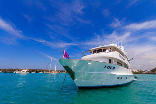 Galápagos Small Ship Voyage cruise ship Eden anchored in turquoise waters, ideal for exploring Eastern Islands with wildlife and snorkeling tours.