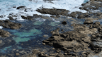 Rocky coastal shoreline with turquoise water, perfect for adventurous outdoor tours and travel along the Great Ocean Walk.