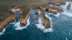 Aerial view of the stunning Twelve Apostles along the Great Ocean Walk, showcasing rugged cliffs and crashing waves.