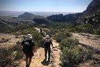 Group hiking on a rugged trail in the Grampians, enjoying breathtaking views and an adventurous outdoor experience.