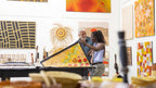 Visitors explore Aboriginal art gallery on Kakadu Katherine Gorge Tour | 4-Day Comfort Travel. Indigenous artwork and cultural learning.
