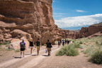 Tour group exploring Charyn Canyon’s rugged trails in Kazakhstan, part of the multi-activity adventure on the 14-23 Day Central Asia Silk Road Tour.