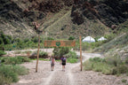 Travelers entering a yurt camp near Charyn Canyon, Kazakhstan, offering enhanced comfort stays on the 14-23 Day Central Asia Silk Road Tour.