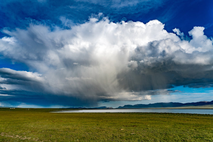 Dramatic rain cloud over Song-Kul Lake in Kyrgyzstan, highlighting the region’s natural beauty on the 14-23 Day Central Asia Silk Road Tour.
