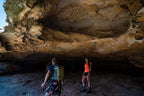 Adventure seekers exploring a stunning rock cave on the Grampians Peaks Trail, embracing the great outdoors.