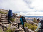 Group of hikers trekking on rocky trail in Northern Grampians, exploring outdoor adventure.