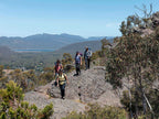 Group of hikers on rugged terrain, enjoying an outdoor adventure in the scenic Grampians.