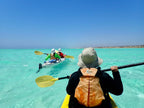 Group kayaking in turquoise waters on the Ningaloo Safari 3-Day Tour. Perfect for guided ocean paddling adventures.
