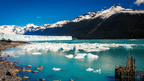Turquoise lake with icebergs and glacier backdrop in Patagonia, featured in the Blue Heart Adventure | 9 Days. Scenic stop on hiking and camping tour.