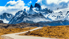 Winding road leading to snow-capped peaks in Patagonia, part of the 9-day Blue Heart Adventure hiking tour through Torres del Paine and Argentina.