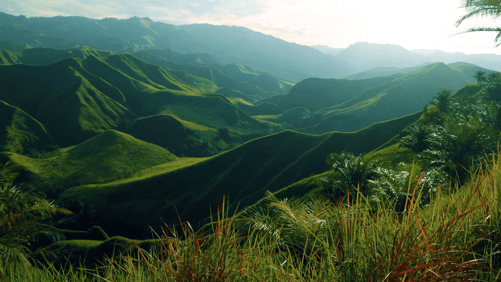 Rolling green hills of Mindanao, scenic landscapes in Philippines Travel Tours - Icons of the Philippines | 10/14/23 Days.