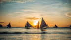 Sailboats at sunset in Boracay, romantic moment in Philippines Travel Tours - Icons of the Philippines | 10/14/23 Days.