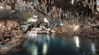 Underground cave pool with stalactites, spelunking adventure in Philippines Travel Tours - Icons of the Philippines.