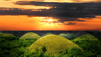 Sunset over Bohol’s Chocolate Hills, a highlight of the Philippines Travel Tours - Icons of the Philippines | 10/14/23 Days itinerary.
