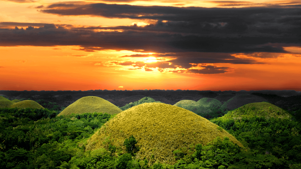 Sunset over Bohol’s Chocolate Hills, a highlight of the Philippines Travel Tours - Icons of the Philippines | 10/14/23 Days itinerary.