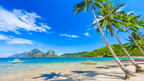 Tropical beach with palm trees and boats in El Nido, featured in Philippines Travel Tours - Icons of the Philippines | 10/14/23 Days.
