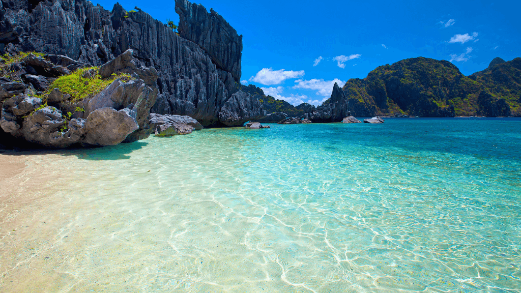 Crystal-clear beach and limestone cliffs in Palawan, tropical paradise in Philippines Travel Tours - Icons of the Philippines.
