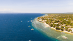 Aerial view of Moalboal coastline with boats, diving hotspot in Philippines Travel Tours - Icons of the Philippines | 10/14/23 Days.