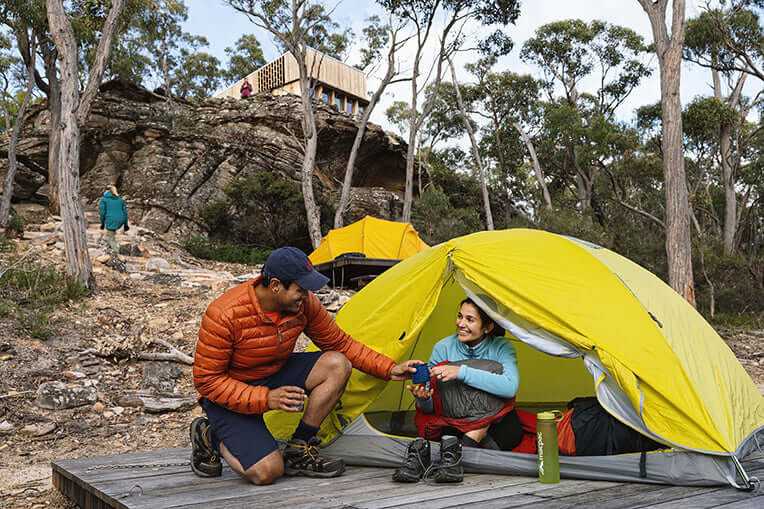Enjoying a cozy outdoor moment at a campsite on a guided adventure through the Southern Grampians.